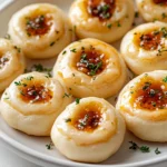 Delve into the delightful world of Cheesy Thumbprint Appetizers with Spicy Pepper Jelly, where flavor meets fun in a bite-sized treat. These delectable appetizers are the perfect fusion of creamy cheeses and a zesty kick from spicy pepper jelly. Each thumbprint offers a unique combination of rich cheddar and tangy jelly, creating a flavor explosion that happens in just one bite. Ideal for gatherings or cozy family get-togethers, these treats are bound to become a staple on your appetizer table.