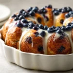 Exploring the delightful world of baked goods, blueberry monkey bread is a treat that combines fluffy dough with the burst of fresh blueberries. This sweet, sticky pastry is perfect for leisurely brunches or as a whimsical dessert. When baking this delicious concoction, the warmth of the yeast, the sweetness of sugar, and the tanginess of lemon juice meld beautifully in each fluffy bite, creating an indulgent experience for your taste buds.