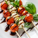 Mini Caprese Skewers with Balsamic Glaze are an exquisite blend of flavors, perfect for any social gathering. Combining the freshness of cherry tomatoes, the creaminess of fresh mozzarella, and the aromatic essence of basil, this dish offers a delightful bite-sized experience. The skewers are not only visually appealing but also come together quickly in just 15 minutes, making them an ideal choice for both casual get-togethers and elegant events.