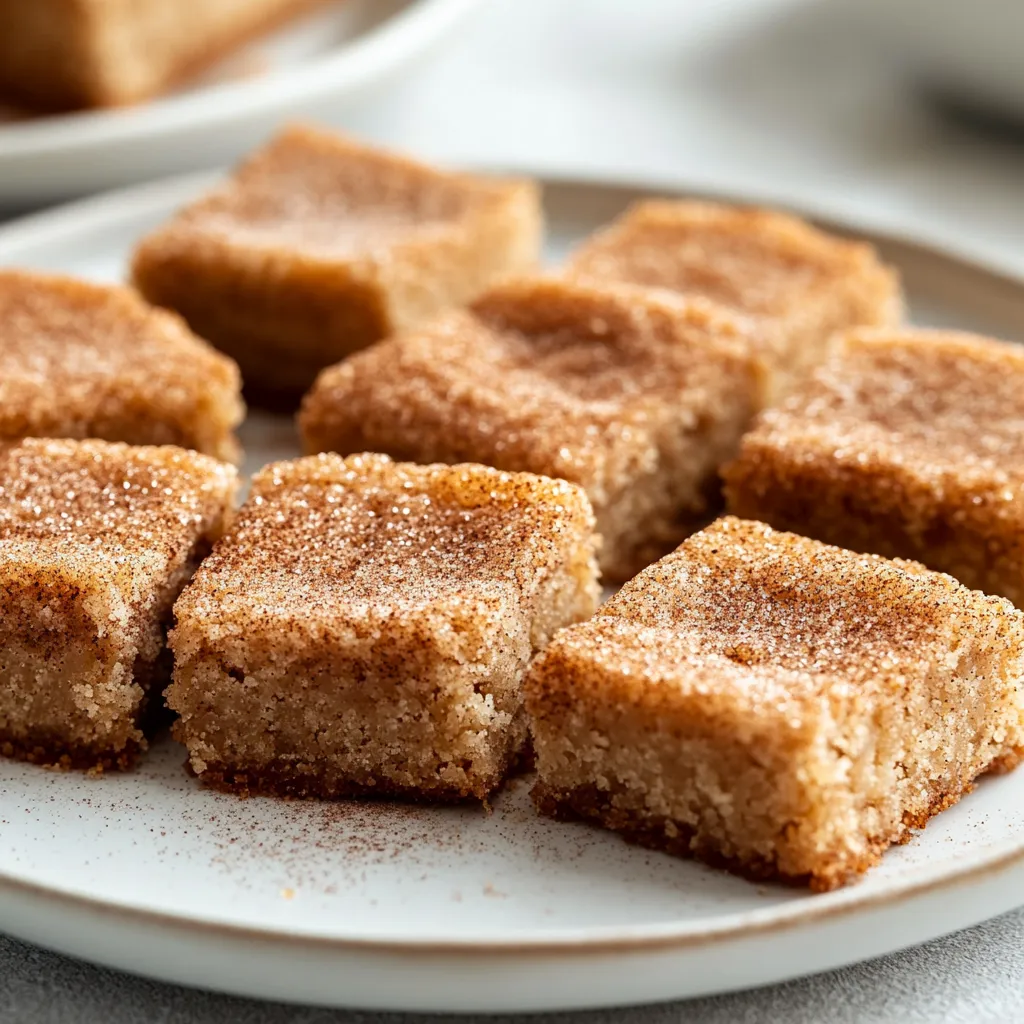 Explore the delightful world of American desserts with these irresistible Snickerdoodle Blondies. Combining the richness of blondies with the warm flavors of cinnamon and brown sugar, this treat is perfect for gatherings or a cozy night in. These blondies are incredibly moreish, boasting all the comforting elements of traditional snickerdoodle cookies while offering a chewy texture that's simply addictive.