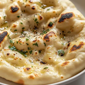 Naan bread is more than just a side dish; it’s a staple of Indian cuisine that has crossed borders to become beloved in many cultures around the world. Traditionally cooked in a tandoor, this flatbread is known for its soft, pillowy texture and slightly charred exterior. When served warm, it’s the perfect accompaniment to a variety of dishes, from rich, spiced curries to flavorful grilled meats.